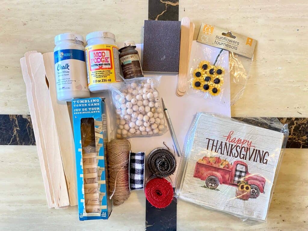 Supplies needed to make the Happy Thanksgiving Truck napkin sign all laid out on a table.
