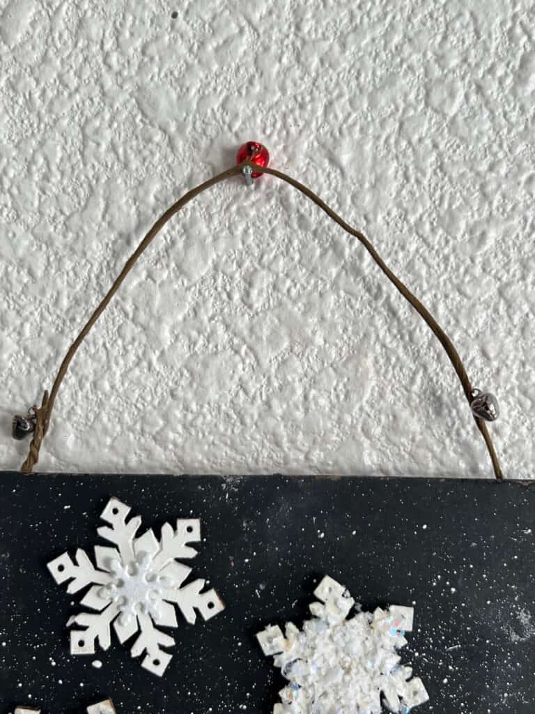 Wired jingle bell hanger on the project hanging on the wall.