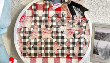 Dollar Tree Merry and Bright Christmas Pizza Pan Door Hanger Wreath with red and white check background and buffalo check wooden word cutout and a messy bow with vintage bling.