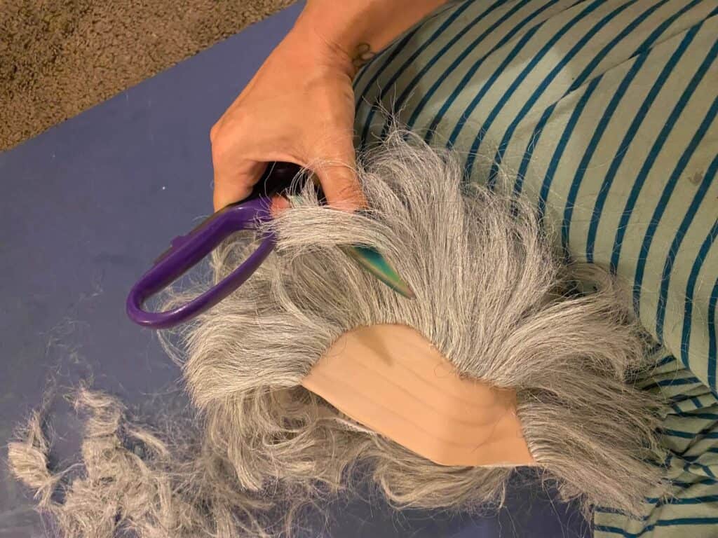 Cutting the benjamin franklin wig to look like Beetlejuice hair.