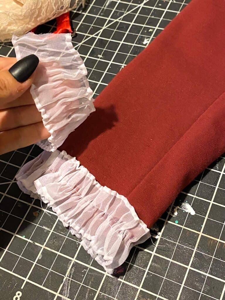 White lace trim glued to the end of the sleeves of the Maroon Wedding beetlejuice suit for the DIY Halloween costume.