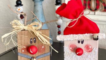 Wood block santa and rudolph the red-nosed reindeer made with 4x4 blocks, painted whimsy faces, wood bead red noses, raffia bow, and faux snowy glitter beard and jingle bells.