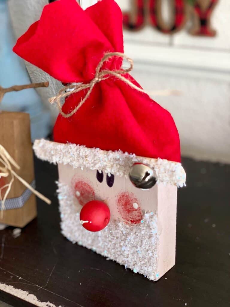 Red felt Santa hat with a silver bell for decoration.