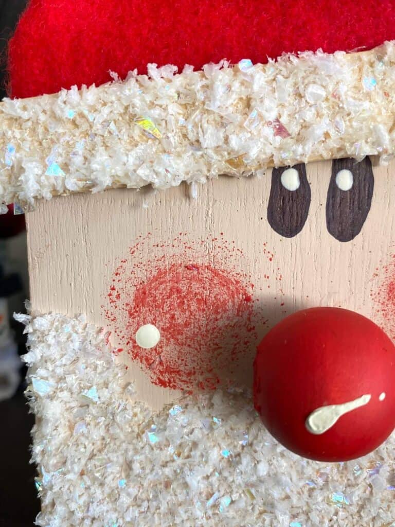 Close up of santas red rosey cheeks.