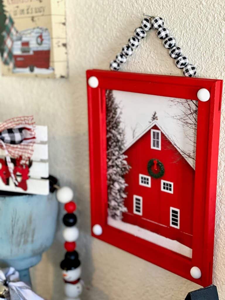 Dollar Tree reverse canvas with a Walmart Red Christmas Barn gift bag to make DIY affordable Christmas decor on a budget.