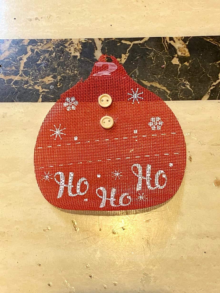 The red burlap piece pulled off of the wooden Christmas Tree ornament.