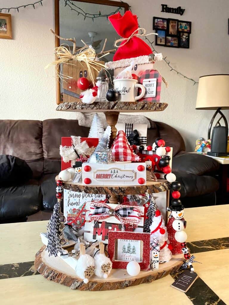 Christmas Rustic Handmade Tiered Tray inspiration for a red, black, and white themed Christmas decorations with traditional Santas, reindeer, Christmas trees, and presents.