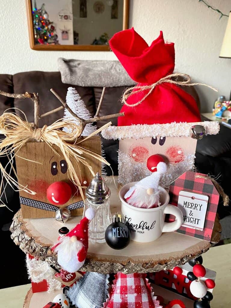 Top tier of the wooden tiered tray with the wood block santa and reindeer, mini gnomes, and mini mug.