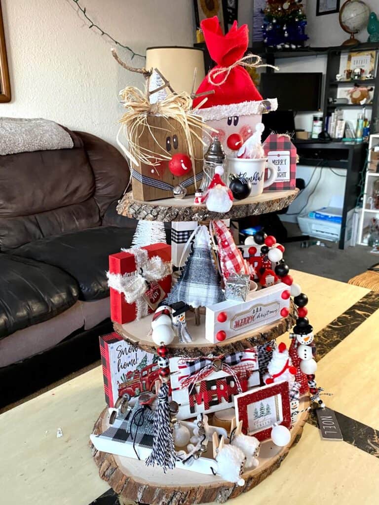 Christmas Rustic Handmade Tiered Tray inspiration for a red, black, and white themed Christmas decorations with traditional Santas, reindeer, Christmas trees, and presents.