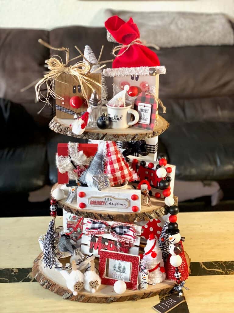 Handmade Rustic Christmas decorated tiered tray with tons of red, black, and white DIY Christmas crafts and decor on all 3 tiers.