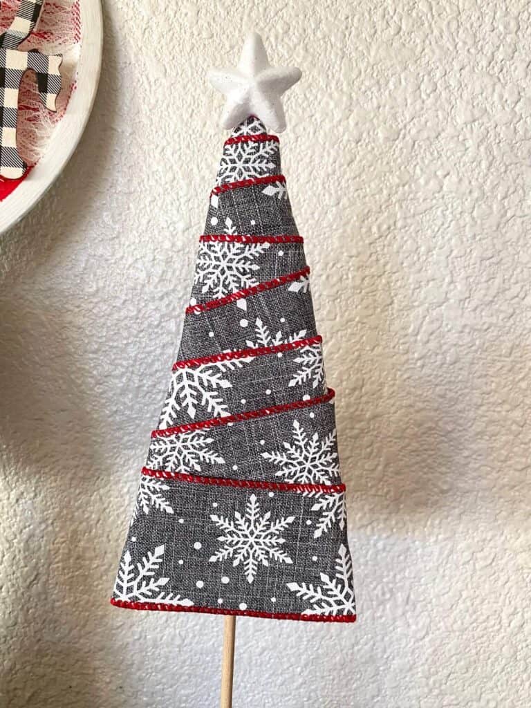 Grey and white snowflake ribbon wrapped Christmas Tree with a white foam star topper.
