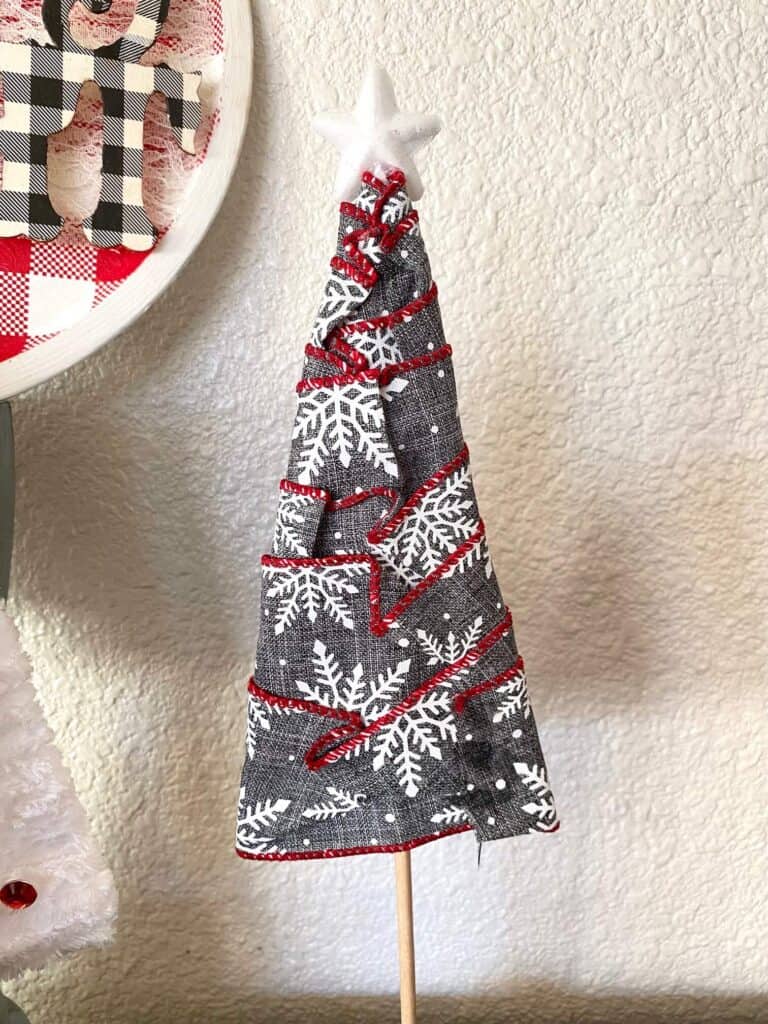 The back of the grey and white snowflake ribbon Christmas Tree showing that the ribbon is folded and glued flat in the back.