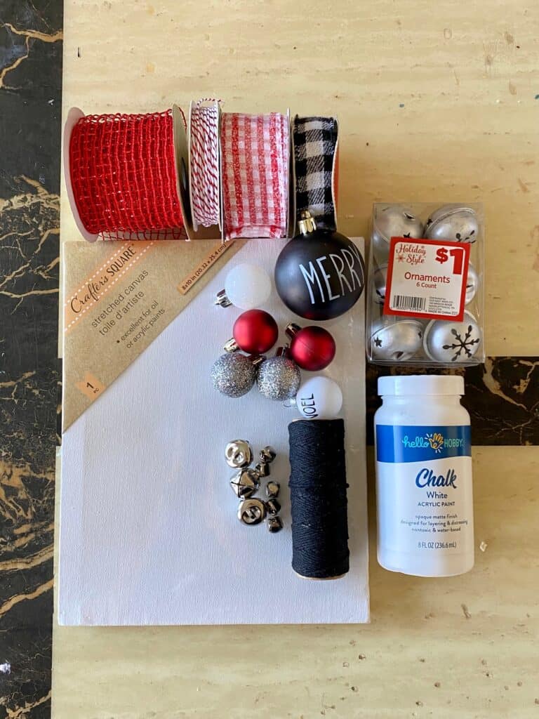 Supplies needed to make a hanging ornament reverse canvas with bulbs and a stretched canvas and ribbon.