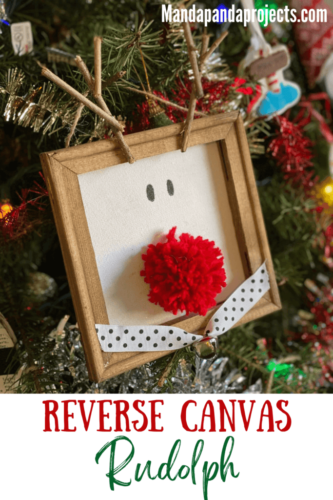 Reverse Canvas Rudolph oversized DIY christmas tree ornament or mini wall decor with a yarn pom pom red nose and sticks for antlers.