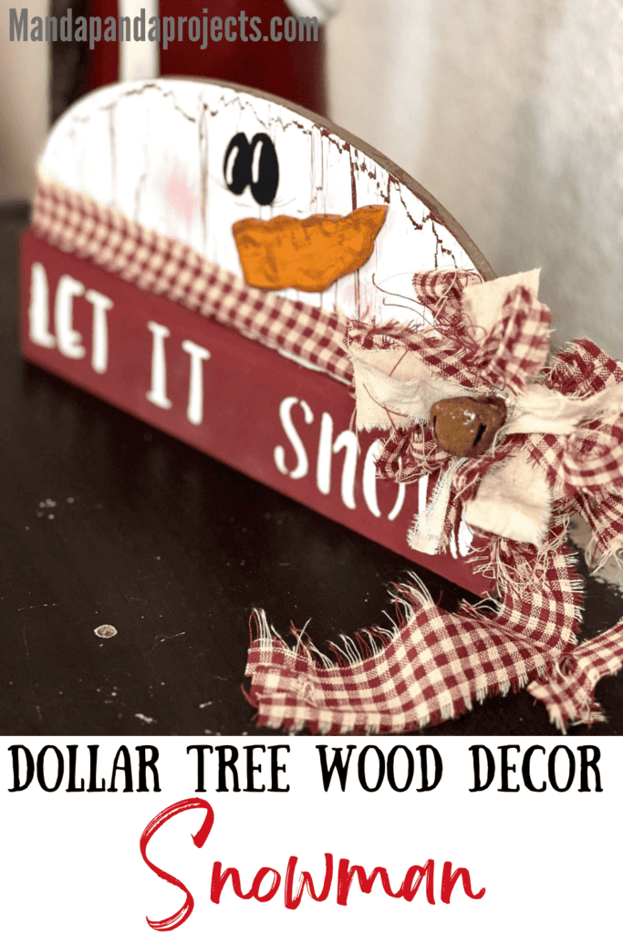 Dollar Tree half wood snowman with white paint and crackle paint underneath, cardboard carrot nose, homespun fabric scarf and bow, and the bottom portion is dark red and say let it snow.