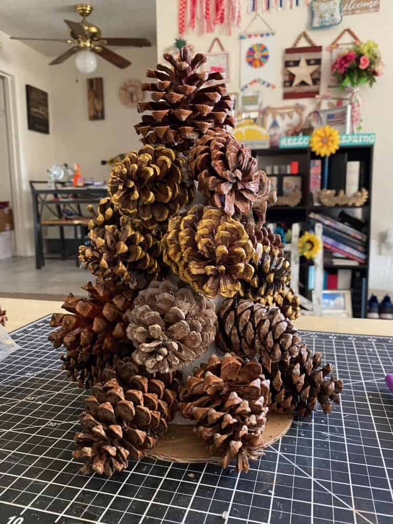 Pine cones completed and glued to a foam cone to make a pine cone christmas tree.