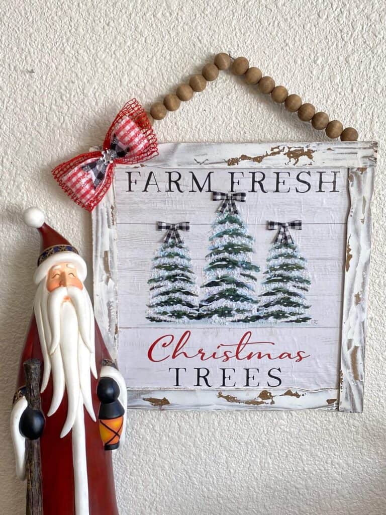 Dollar Tree Calendar December print Farm Fresh Christmas Trees sign made with paint stick frame and a wood bead hanger.