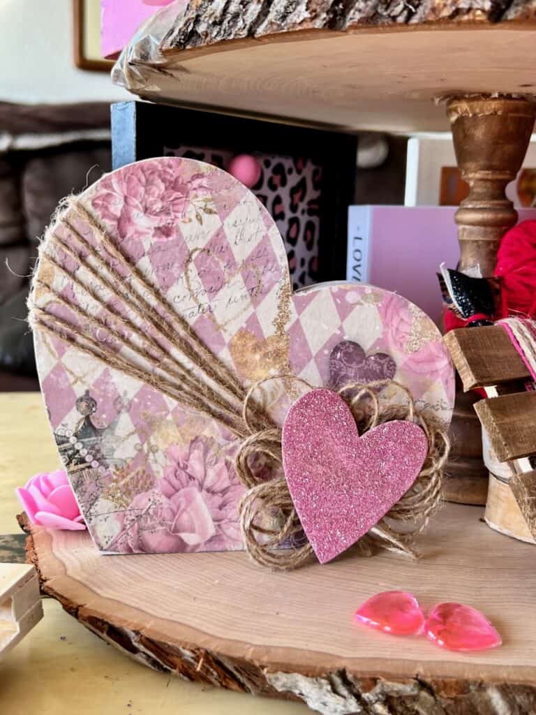 Wood dollar tree heart with glamentine purple rice paper decoupaged with twine and a purple glitter heart across the front.