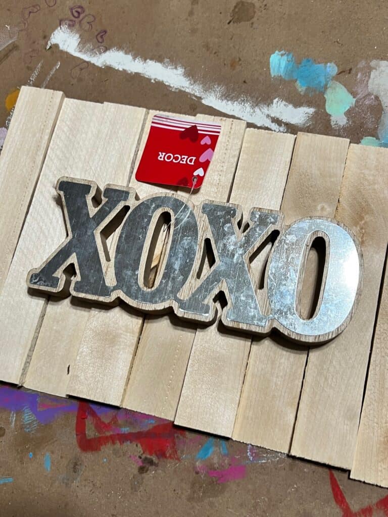 Supplies needed to make the pink ombre XOXO sign with a wood and metal XOXO cutout.