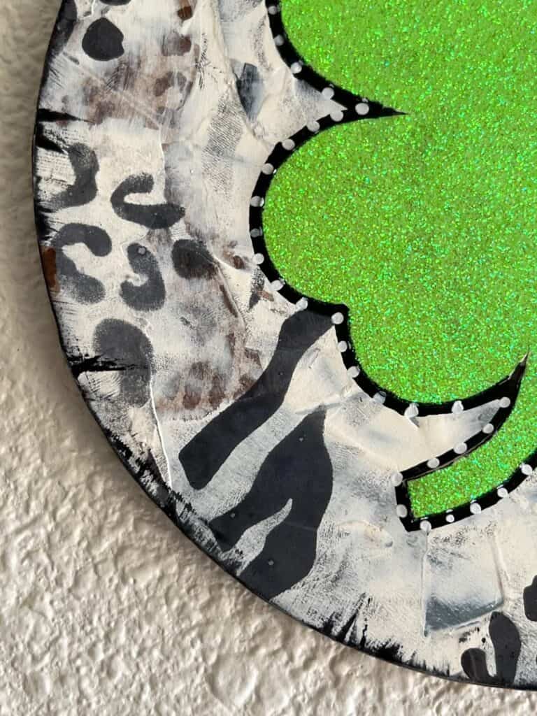 Close up showing the animal print stencils on the black and white patchwork background.