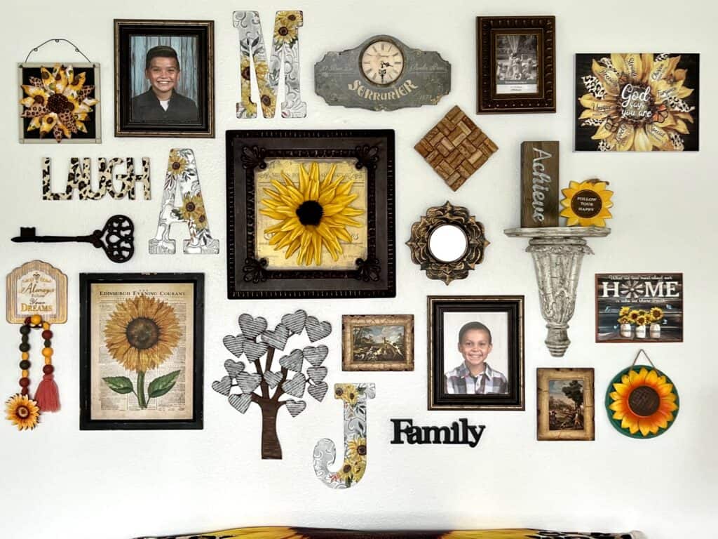 Sunflower themed gallery wall with leopard print accent pieces, designed with thrifted, unique, handmade decor that makes a bright and cheery vibe in a living room.