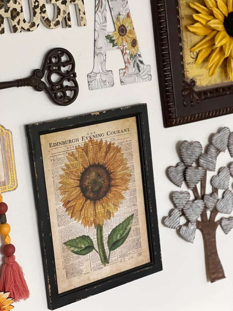 A vintage newspaper frame with a sunflower painted on it.