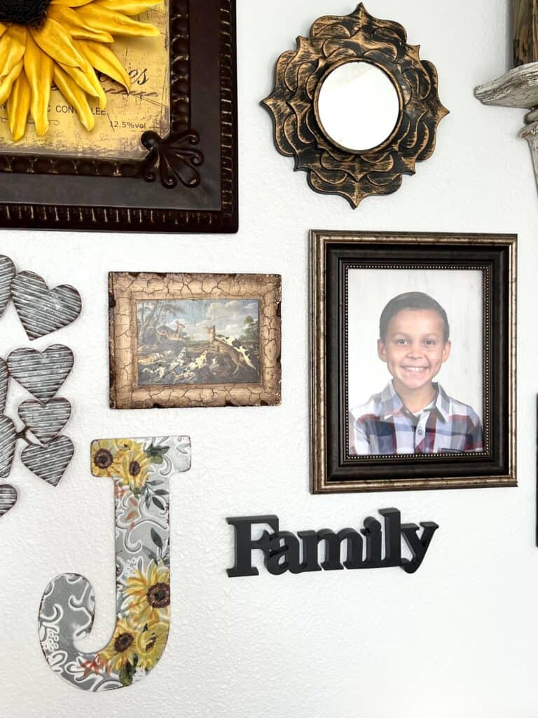 A round mirror, photo of justice, the letter J, the word "Family", and a crackle frame.