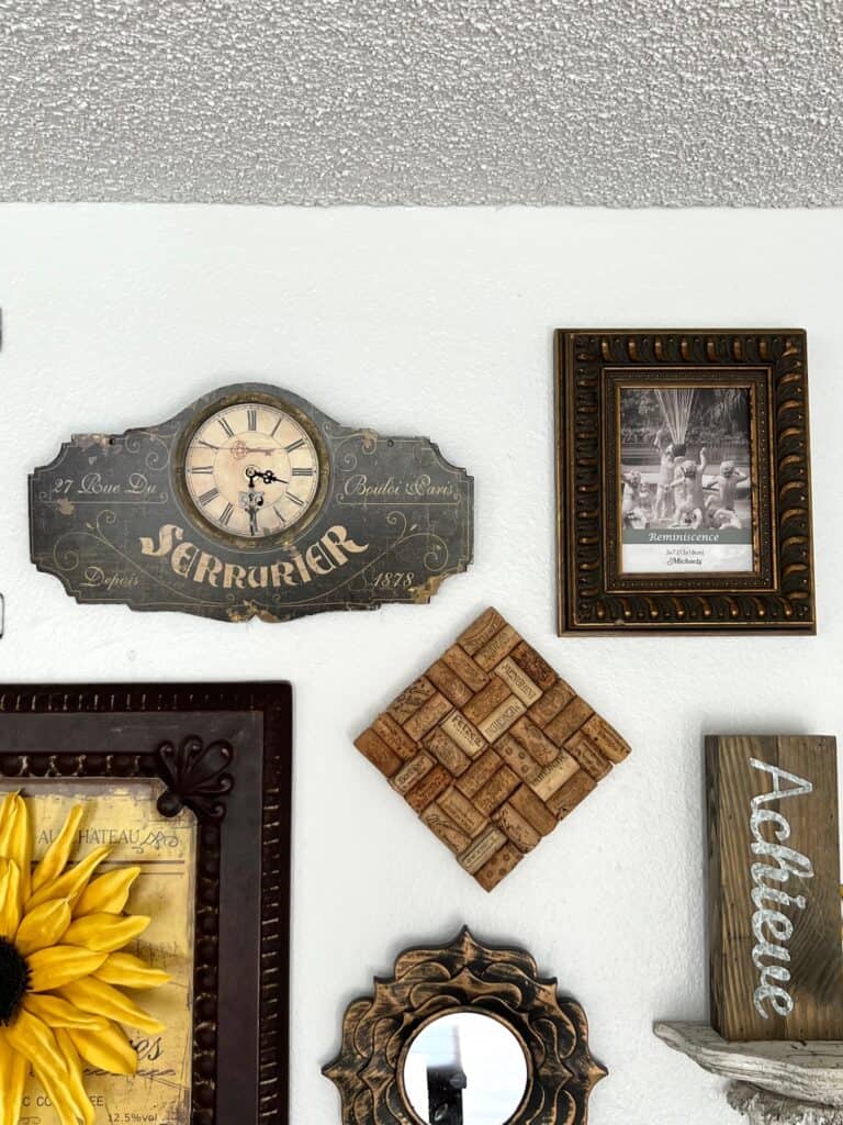 A vintage french clock, wine cork hot plate, and chunky brass picture frame.