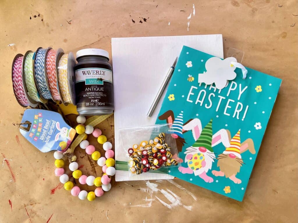 Supplies needed for a reverse canvas decor with a gnome bunny Easter gift bag from walmart.