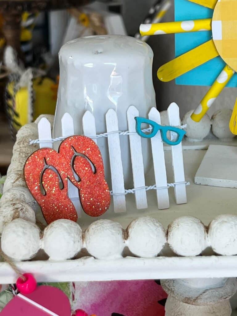 Mini Beach fence with flip flops and sunglasses.