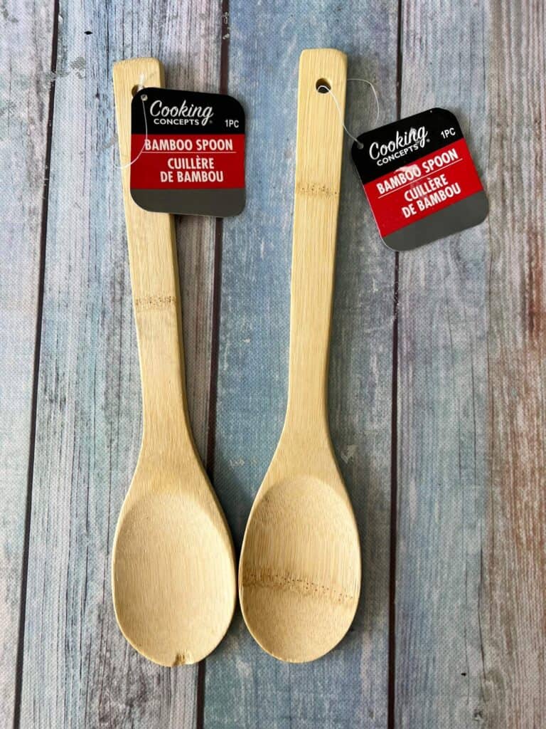 2 Dollar Tree wood spoons with the tags on that say "Bamboo Spoon".