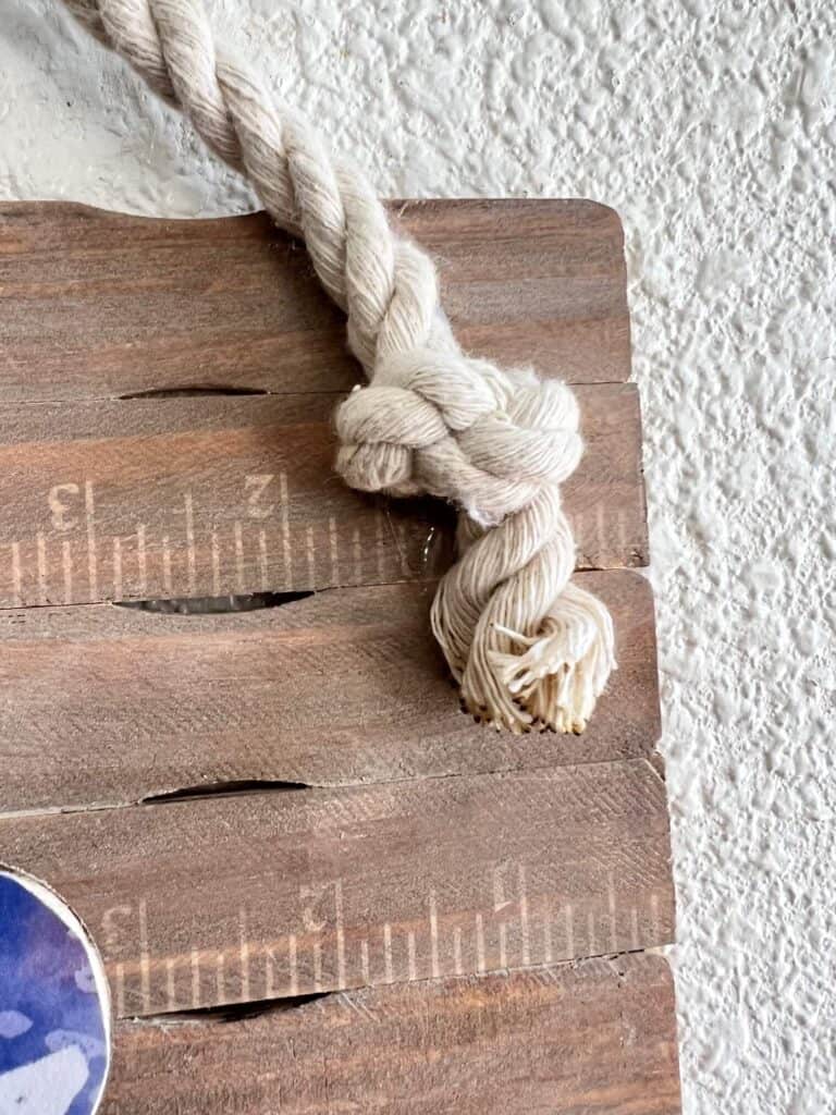 Nautical rope hanger glued to the top of the project with burnt ends.