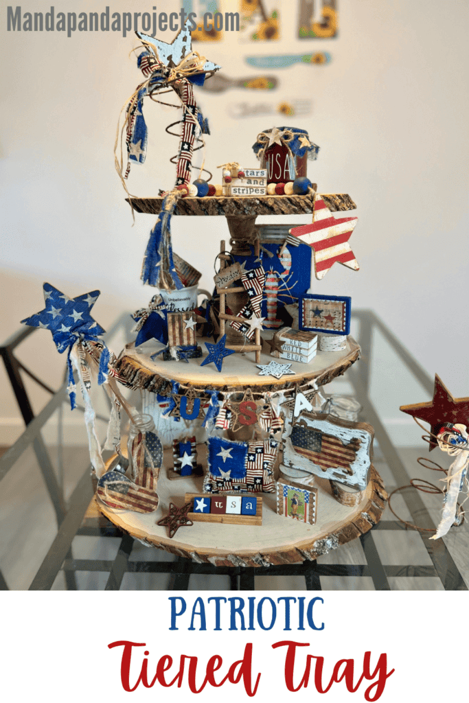 Patriotic Rustic Tiered Tray decorated with handmade mini 4th of july americana crafts and DIY decor on all 3 tiers of the large wooden round tray. Red white and blue crafts and decor.