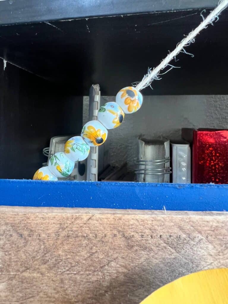 The ceramic sunflower beads on a twine hanger.