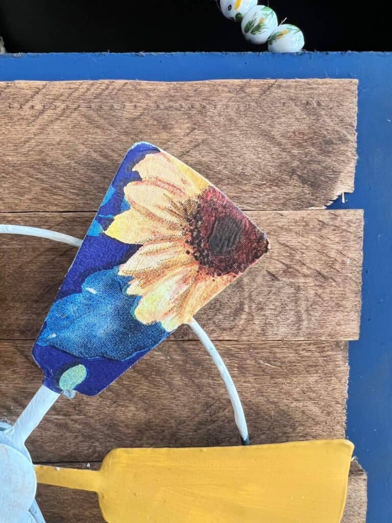 One of the windmill blades with the navy blue sunflower napkin mod podged to it.