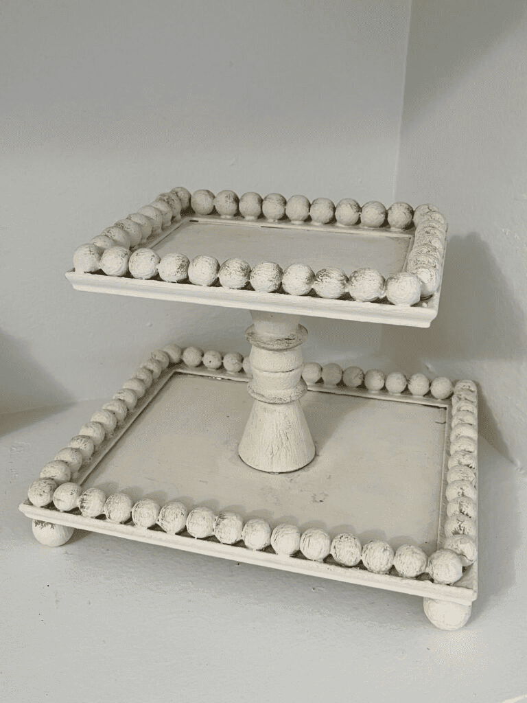 Empty White 2 tiered rectangular wooden tray with beaded rim.