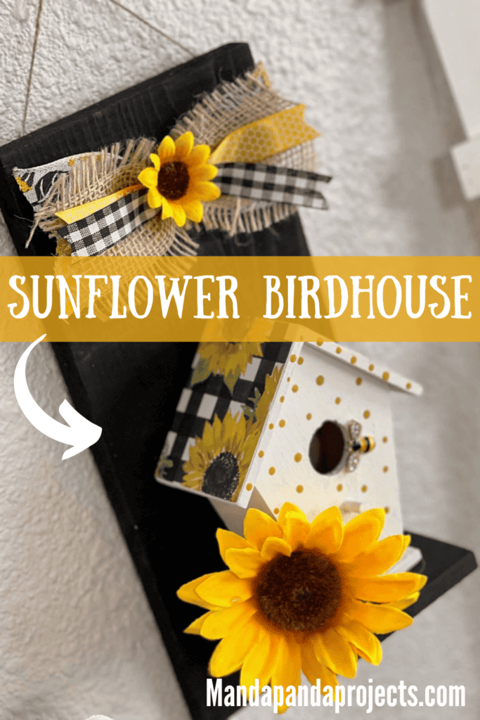 Sunflower Birdhouse Decor with a wood birdhouse, black wood background, sunflower scrapbook paper roof, and little yellow polka dots with a small burlap bow on the top.