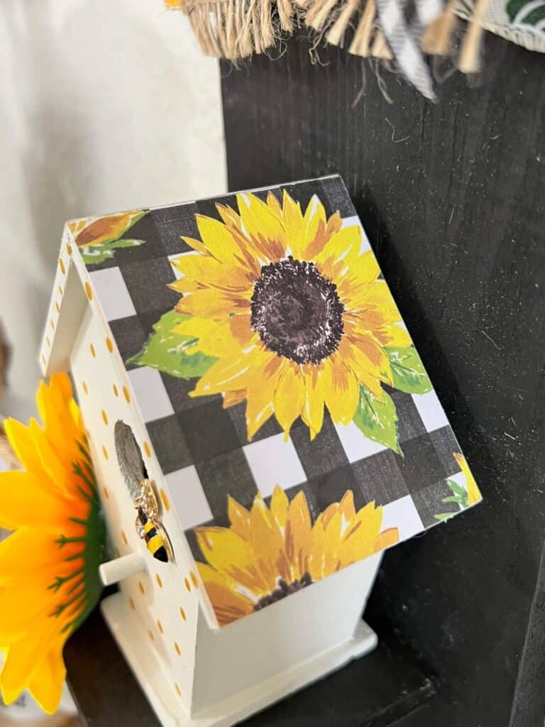 The roof of the birdhouse covered with sunflower and buffalo check scrapbook paper.