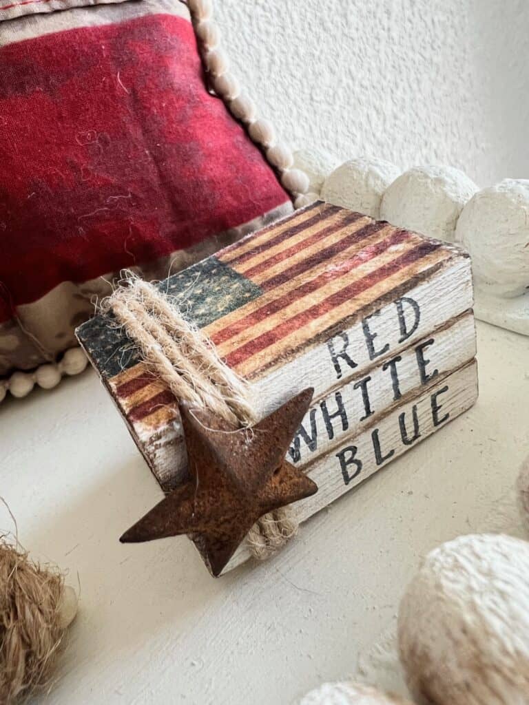 Patriotic Mini Jenga Block Bookstack decor for a 4th of July Americana themed tiered tray with a vintage american flag and a rusty star that says "red, white, and blue". Summer crafts and decor.