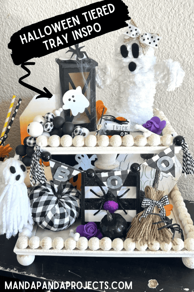 DIY Handmade Halloween Tiered Tray on a white wood bead 2 tiered tray with ghosts, spiders, witches broom, pumpkins, bones, frankenstien, mummy and other Halloween decor.