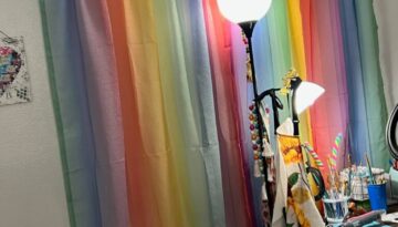 Rainbow curtains hanging in a craft room.