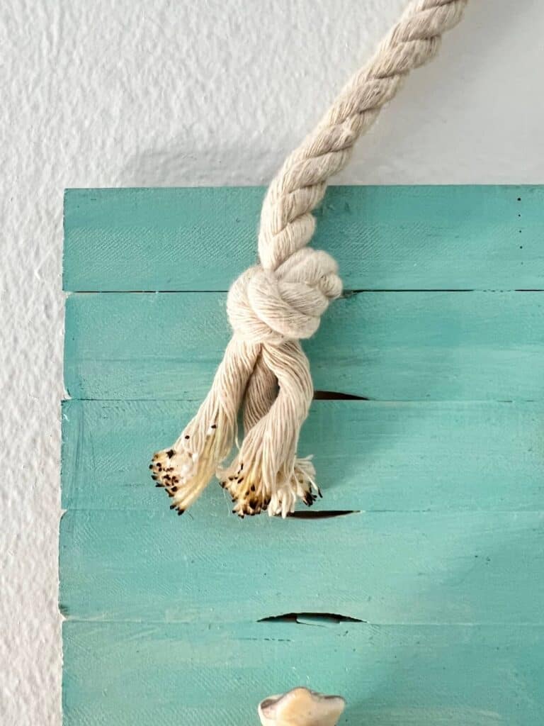 The and of the white nautical rope with the ends singed.