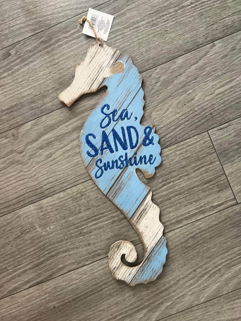 Dollar tree seahorse with blue and white faux wood surface
