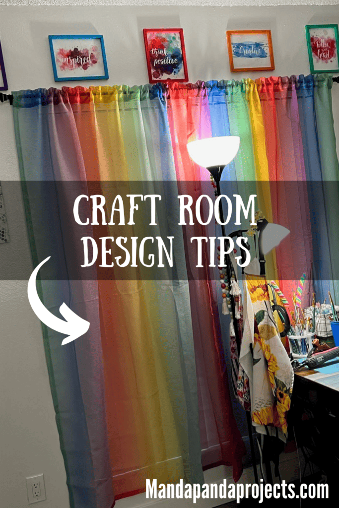 Rainbow curtains hanging in a craft room with a bright light in front and colorful quote designs in frames above the window.