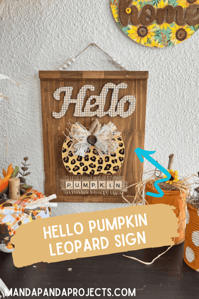 Hello leopard pumpkin DIY fall decor with a stained paint stick background, pearl bead hanger, lace and burlap bow, and  scrabble tile letters.