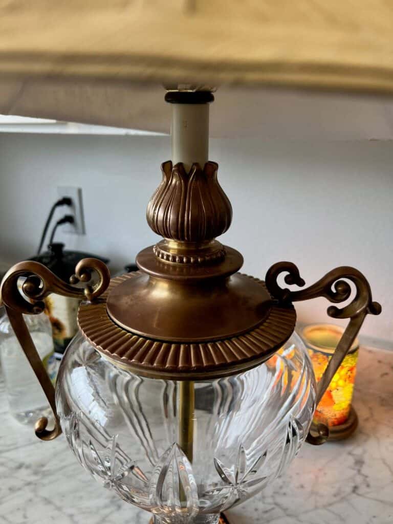 The top brass portion of the lamp completely restored back to its natural brass color.
