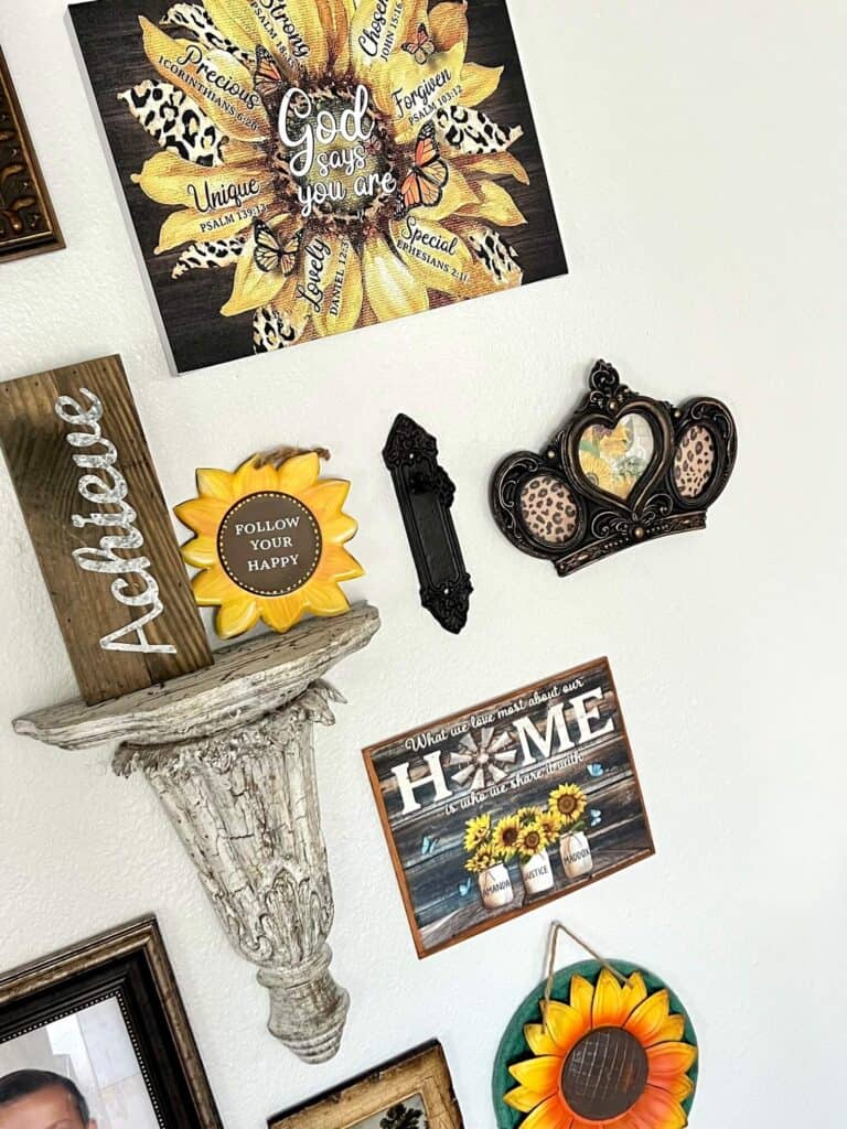 Thrift store crown makeover with gold and black, and leopard print and sunflower inside the frame, hanging on the wall next to an old vintage doorknob.