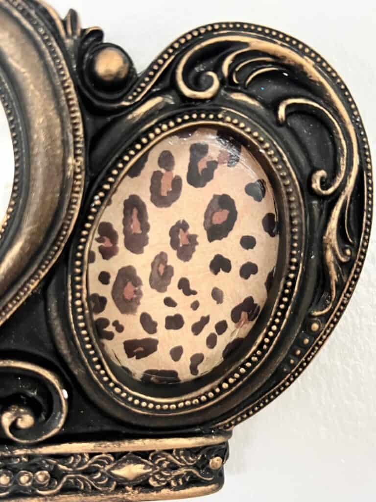 The right and left picture frames on the crown are oval, and inside is leopard print scrapbook paper.