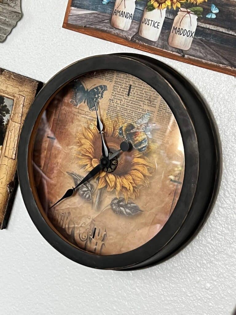 Sunflower Thrift Store Clock Makeover hanging on a gallery wall with other sunflower statement pieces.