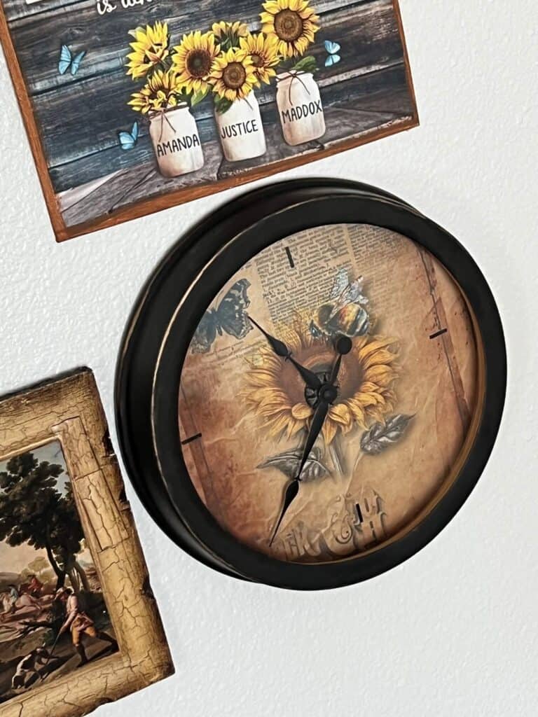 Sunflower Thrift Store Clock Makeover hanging on a gallery wall with other sunflower statement pieces.